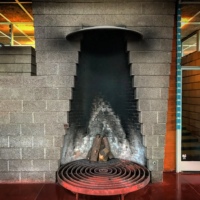 The left edge of the stepped negative space of the Harold Price Sr. fireplace shows a remnant of what was once a crane and concave bowl-shaped firebasket.