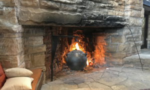 The Hillside drafting room fireplace with kettle ablaze.