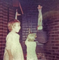 Julia and David Burris hang Christmas stockings in the fireplace. The kettle was already showing some rust.