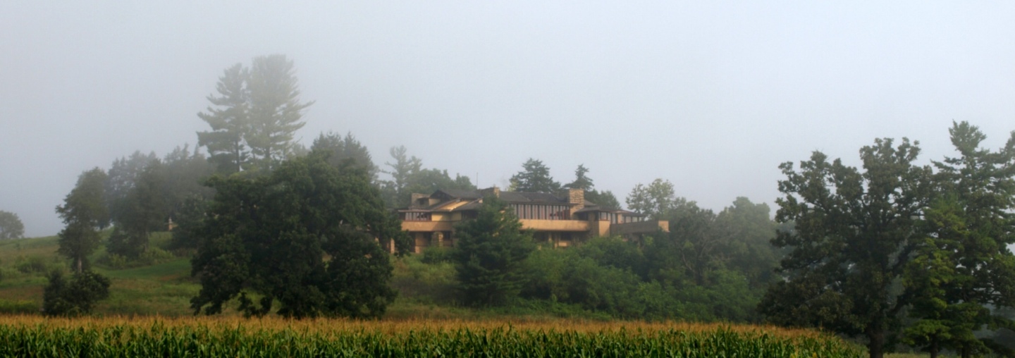 Frank Lloyd Wright's Wisconsin home, Taliesin, is seen in fog, across a field of corn