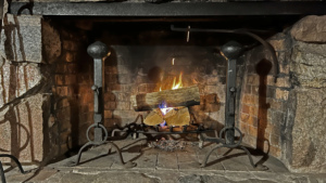 A simple pot crane inside a 1915 Arts & Crafts fireplace.