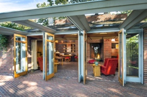 The patterned series of French doors open the living spaces of the Willey House to the outside.